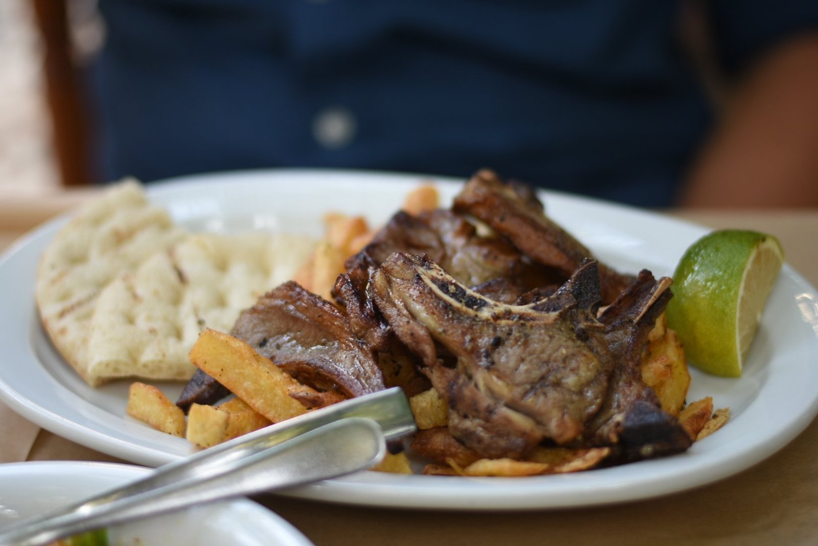 Grilled lamb ribs with pitta and fries